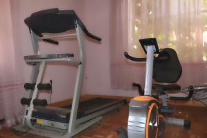 a treadmill and a exercise bike in a room at Bankhouse Retreat Karen in Nairobi