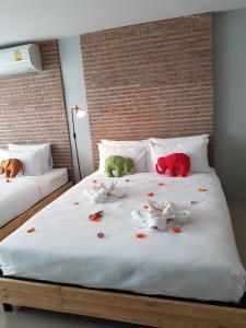 a bed with stuffed animals on top of it at PUNSUK@PRASING in Chiang Mai