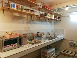 a kitchen with a counter with a microwave at Silla House in Hat Yai
