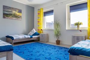 a bedroom with two beds and a blue rug at Ferienwohnung in Witten