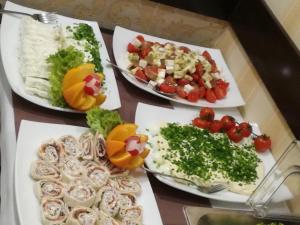 a table with three plates of food on it at Pensjonat Gaborek in Krynica Zdrój