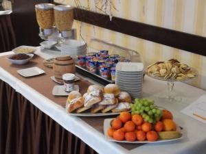 a buffet with plates of food on a table at Pensjonat Gaborek in Krynica Zdrój