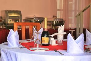 a table with a bottle of wine on top of it at Bankhouse Retreat Karen in Nairobi
