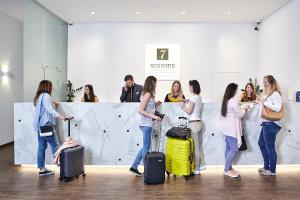 a group of women standing in a room with luggage at 7Seasons Apartments Budapest in Budapest +38 photos