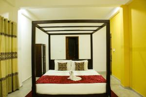 a bedroom with a bed with a wooden frame at Villa Marina Hikkaduwa in Hikkaduwa +54 photos