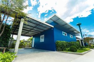 a blue building with a roof at P House in Kanchanaburi City