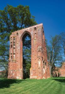 a brick building with an arch in the middle of a field at Hanse Haus Pension in Greifswald