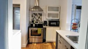 a kitchen with a sink and a stove top oven at Beside The Tulip Tree in Shelburne