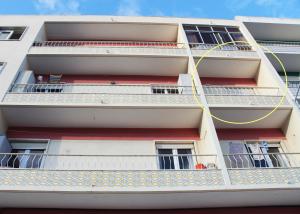 an apartment building with balconies and a yellow rope at Ana's Guesthouse in Sintra