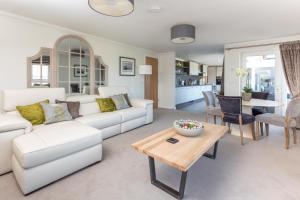 a living room with a white couch and a table at Links View - Donnini Deluxe in Prestwick