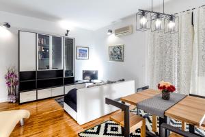 a living room with a dining table and a large television at Apartment Majo in Split