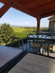 a group of tables and chairs on a patio at Gite de prejeurin in Échalas +18 photos