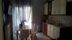 a kitchen with a table and chairs and a window at Amazing Apartment In The Center in Alexandroupoli