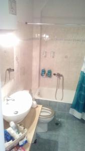 a bathroom with a sink and a toilet and a tub at Amazing Apartment In The Center in Alexandroupoli +33 photos