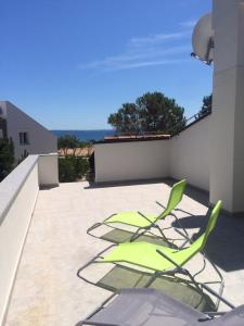 two green chairs sitting on a patio at Studio Apartment Branko in Novalja +6 photos