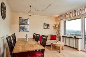 a living room with a table and a couch at Pension Haus am Einberg in Meschede