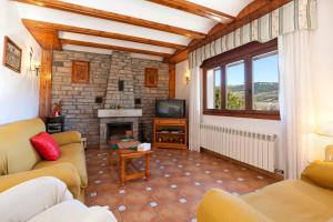 a living room with a couch and a fireplace at Casa Rural Saura in Alcalá de la Selva