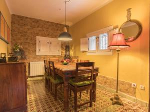 a kitchen with a table with chairs and a lamp at Los Prejones in Arenas de San Pedro