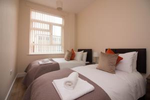 a bedroom with two beds and a window at DPV - Above Bar Street Apartments in Southampton