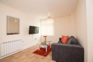 a living room with a couch and a tv at DPV - Above Bar Street Apartments in Southampton