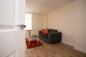 a living room with a couch and a table at DPV - Above Bar Street Apartments in Southampton