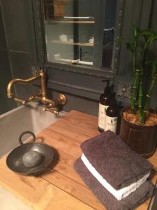 a kitchen sink with a towel on a cutting board at Elm Cottage Barn in Oatlands