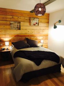 a bedroom with wooden walls and a large bed at les Gîtes de la limonaderie in Strasbourg