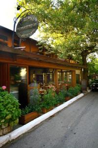 a restaurant with potted plants in front of it at Hotel Papanastasiou in Elati