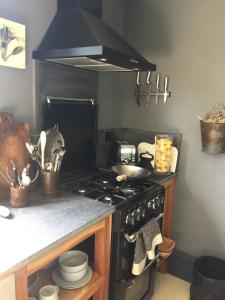 a kitchen with a stove and a counter top at Elm Cottage Barn in Oatlands