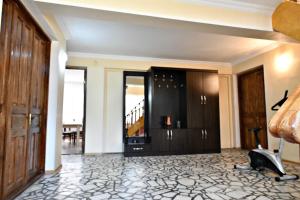 a living room with a door and a room with a floor at Hotel Good Luck in Kutaisi