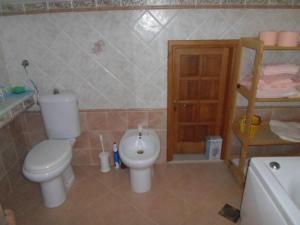 a bathroom with a toilet and a sink at Apartments villa MaVeRo in Banjole
