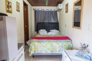 a small bedroom with a bed in a room at Green Mountain Pousada in Florianópolis