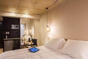 Voodi või voodid majutusasutuse Hotel Ciudadano Suites toas