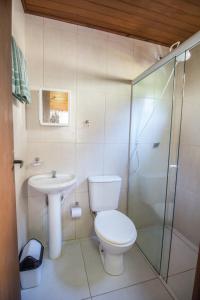 a bathroom with a toilet and a sink and a shower at Green Mountain Pousada in Florianópolis