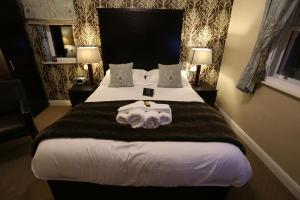 a hotel room with a bed and a desk at Woodlands in Windermere