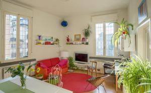 a living room with a red couch and a red rug at Zip b&b . design in Florence in Florence