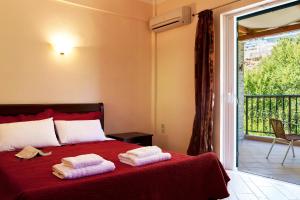 a bedroom with a bed with two towels on it at Azalea in Vasiliki +35 photos