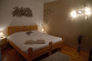 a bedroom with a bed with two towels on it at Auberge de Portout in Chanaz