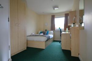 a small bedroom with a bed and a window at Newport Student Village (Campus Accommodation) in Newport