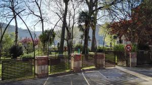 a gate in a park with trees and a no parking sign at La Chantrerie in Cahors