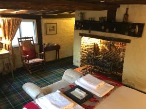 a living room with a fireplace and a couch at Thatched Cottage Hotel in Brockenhurst