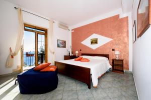 Un dormitorio con una cama grande y una ventana. en Villa Gioiello, en Amalfi