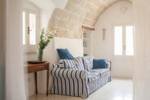 a living room with a couch and a table at Elena's House 6 in Polignano a Mare
