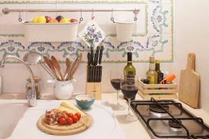 a kitchen counter with a plate of food and wine at Elena's House 6 in Polignano a Mare +9 photos