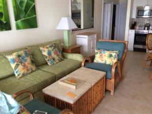 a living room with a couch and chairs and a table at Coconut Beach Resort in Key West