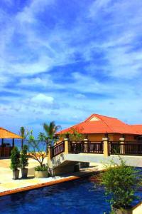 ein Haus mit einem roten Dach und einem Pool in der Unterkunft Peace Paradise Beach in Ko Lanta