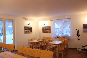 a dining room with a table and chairs at Sielski Zakątek in Cisna