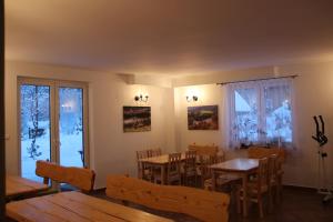 a dining room with tables and chairs and a window at Agroturystyka Sielski Zakątek Aneta i Hubert Wierzbiccy in Cisna
