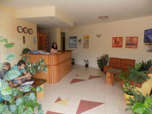 a waiting room with people sitting at a counter at Sirena Hotel in Kranevo