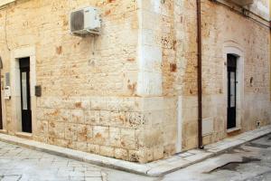 a brick wall with an air conditioner on a building at Dimora Morello in Turi